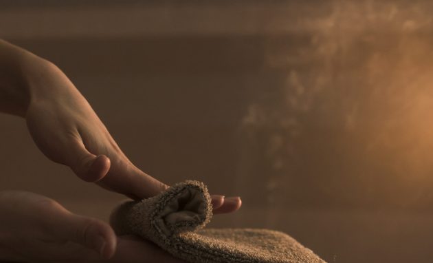 beautician-hand-massaging-woman-s-back-with-hot-towel-spa